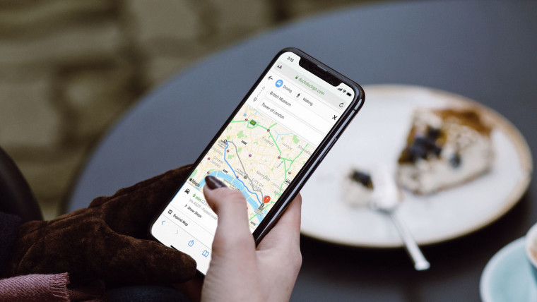 A woman using DuckDuckGo map directions on a smartphone