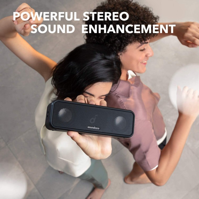 woman holding an anker soundcore speaker