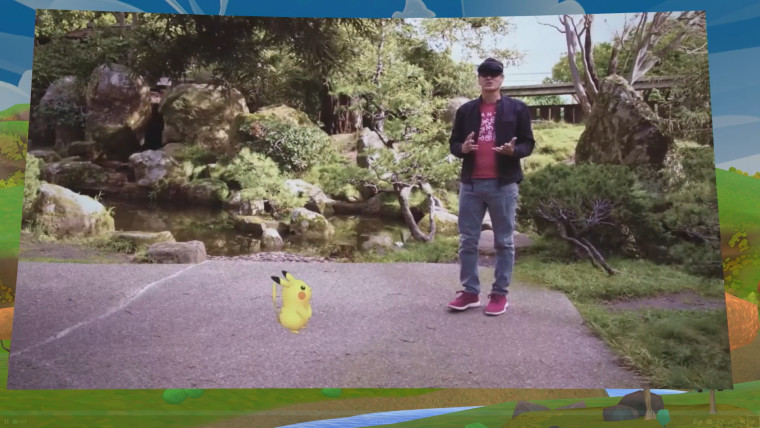 A man wearing a HoloLens standing behind a Pikachu virtual avatar on Pokemon GO