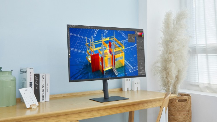A flat Samsung monitor on a wooden desk