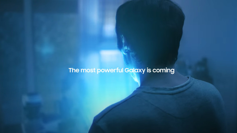 Screen grab from Samsung&039s teaser showing a man turning his back to face a box glowing in blue li