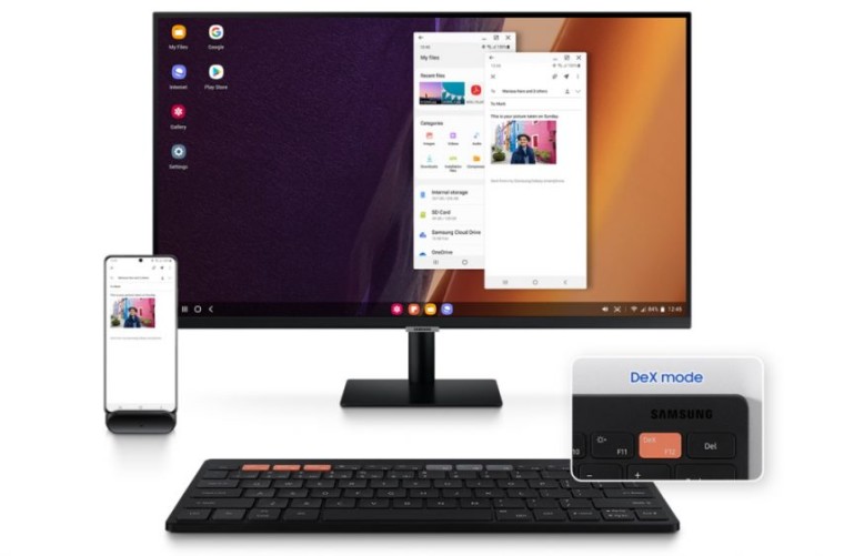 Samsung Smart Keyboard Trio 500 next to a monitor and Samsung phone in DeX mode