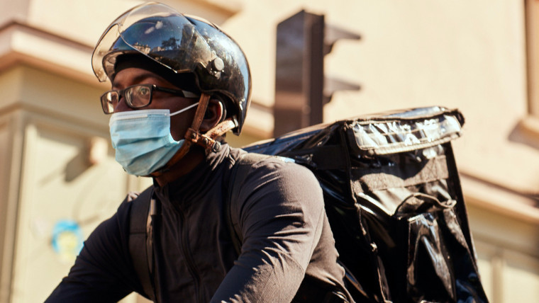 A cyclist riding for Uber