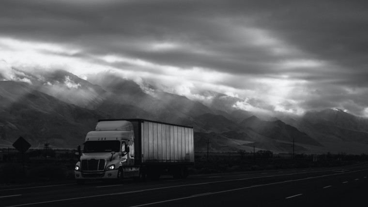 A truck travelling on a very cloudy day