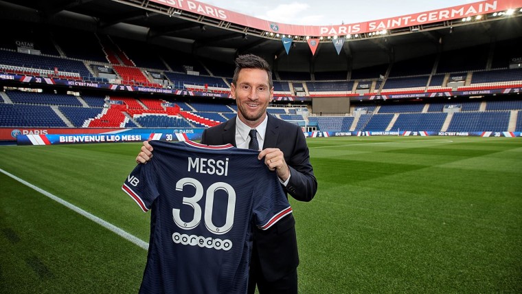 Messi holding his new No 30 PSG jersey