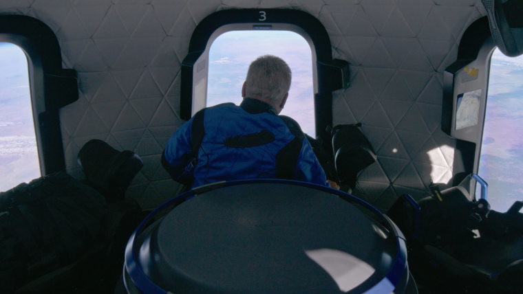 William Shatner looking out of the window into space
